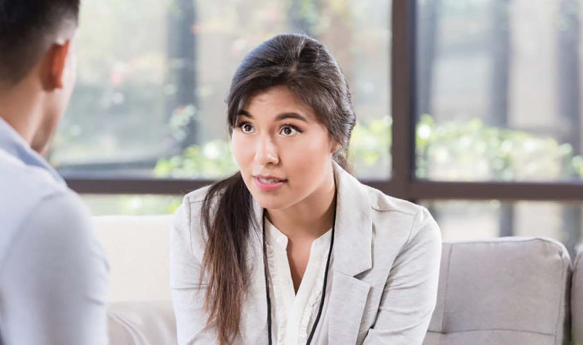 Woman engaging in a thoughtful conversation, illustrating an open and supportive approach to discussing mental health with family or loved ones.