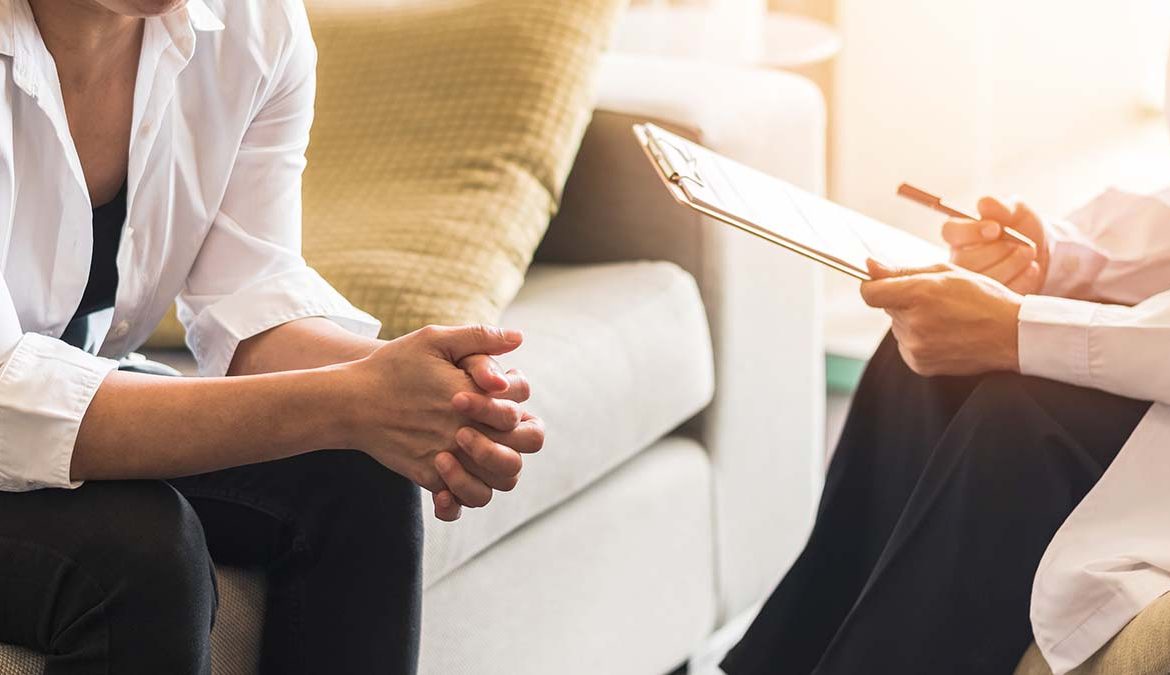 Image of a person in therapy, demonstrating the challenges faced by individuals with Delusional Disorder. The person appears engaged in a conversation, suggesting the importance of professional support in managing this mental health condition.