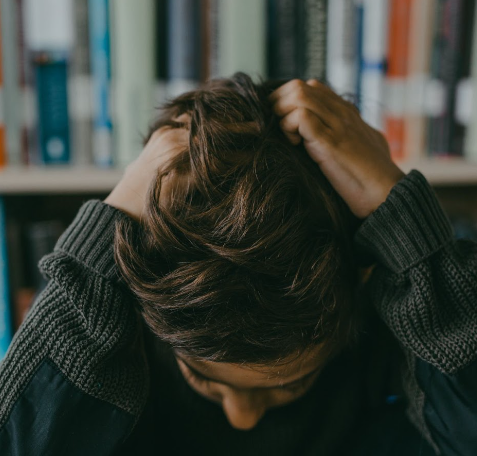 man pulling his own hair