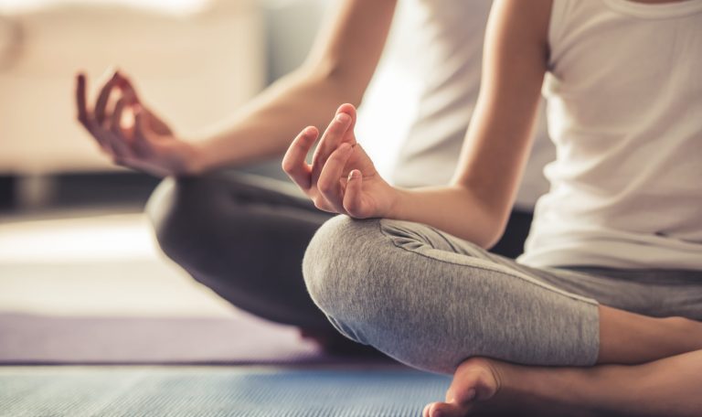 Mom and daughter doing yoga