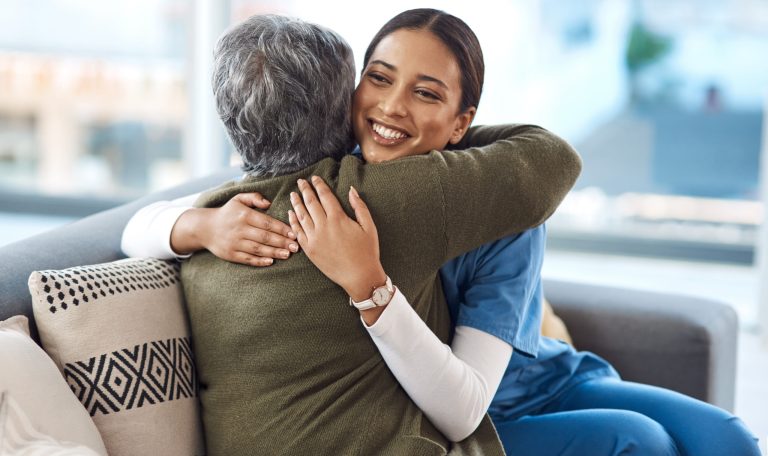 Its been a pleasure. an attractive young female nurse embracing her senior patient