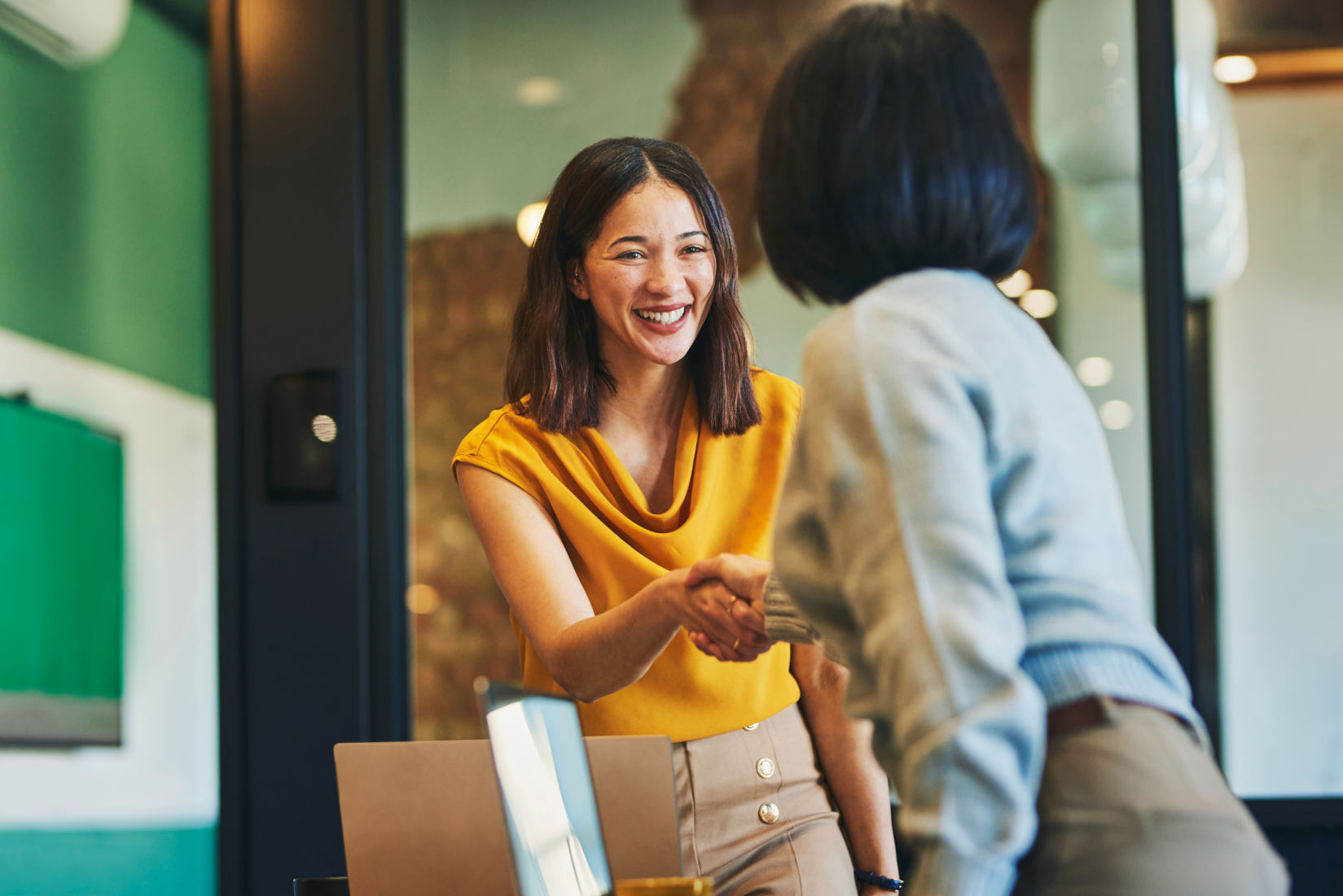 Two women discussing courses for professionals.