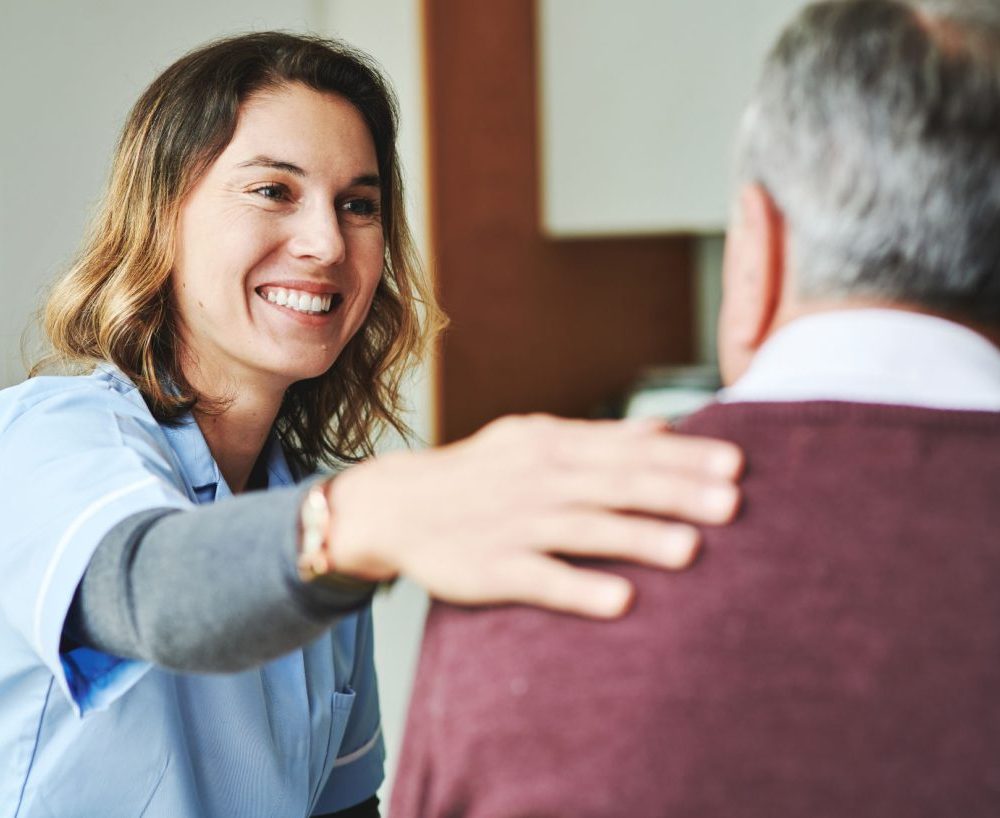 Genoa Healthcare provider offering support to a patient.