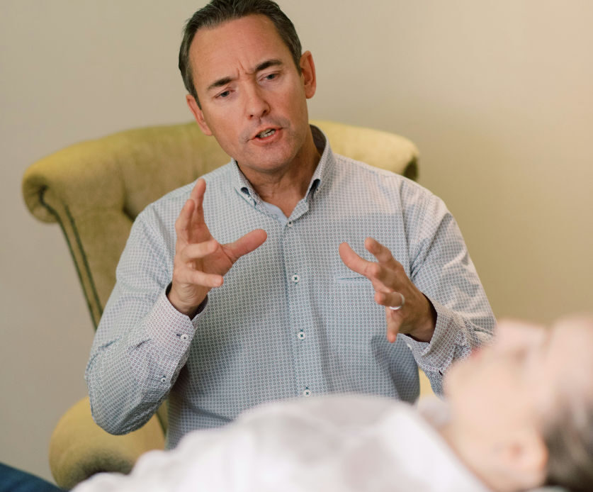 
A therapist speaking to a patient, reflecting the importance of seeking professional help for managing bipolar disorder.