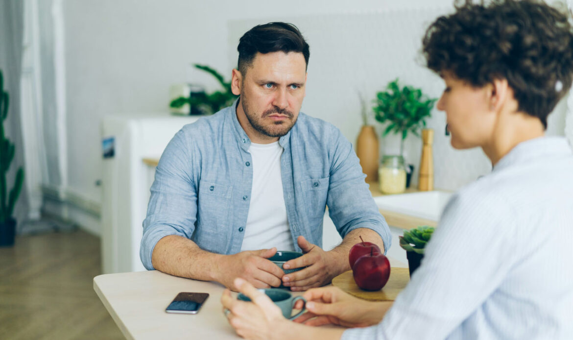 Two people in a tense conversation, representing the challenges of trauma bonding in an abusive relationship.