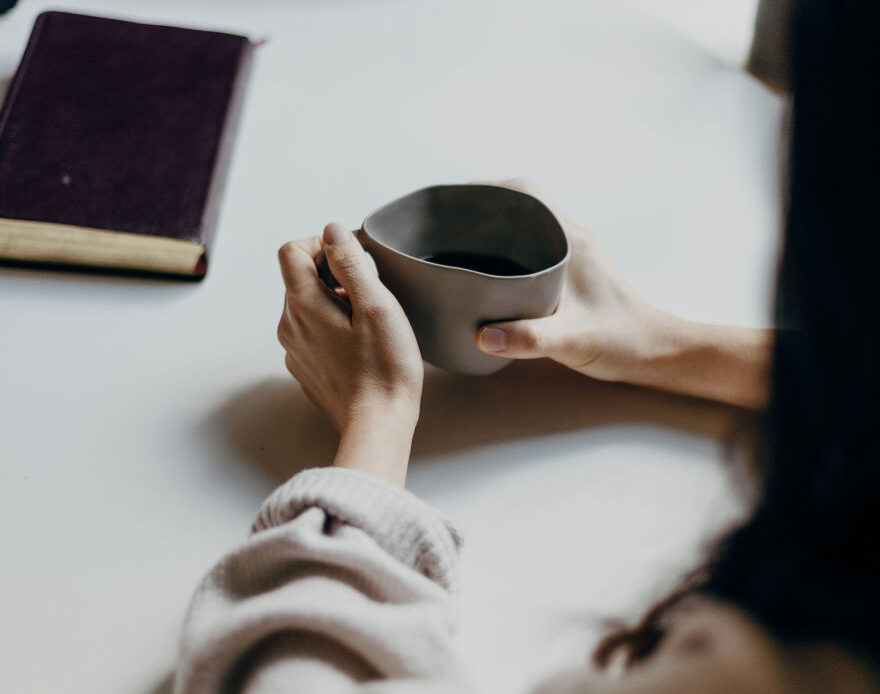 Two people sharing a quiet moment over coffee, symbolizing a safe and supportive space for emotional healing.