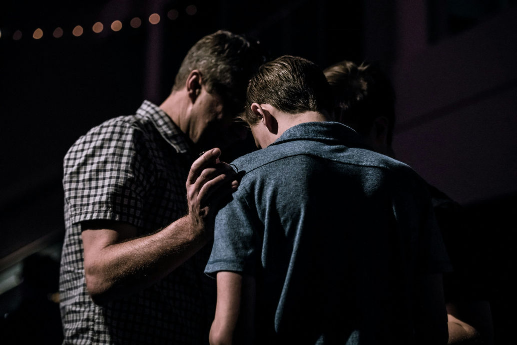 Seeking Support in Grief and Mourning shown with a group sharing a moment of comfort.