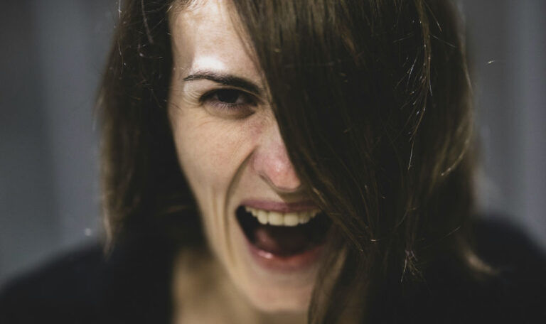 A woman showing intense emotion, crying while feeling mad, illustrating why someone might cry when they get mad.