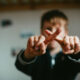 Child crossing fingers related to what to say to someone who lost a loved one.