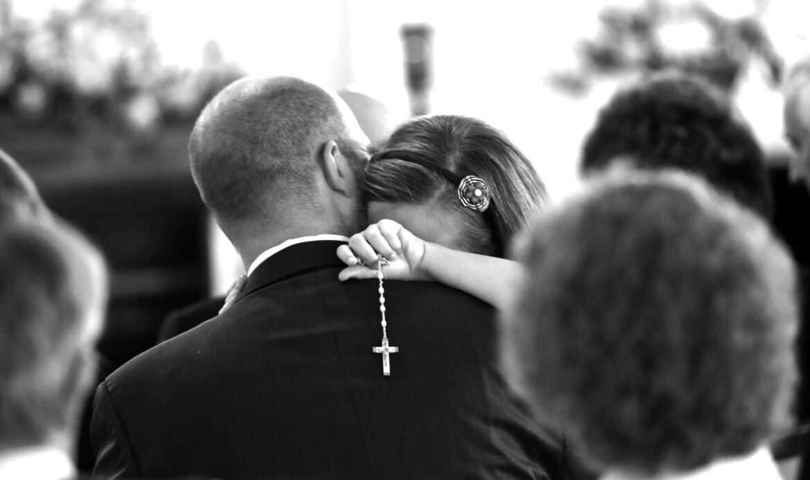Man in suit kissing woman, black-and-white photo