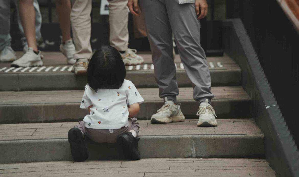 Toddler sitting on outdoor stone steps