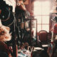 A vintage room filled with various hats, chairs, and accessories, symbolizing the process of exploring options and finding direction in life.