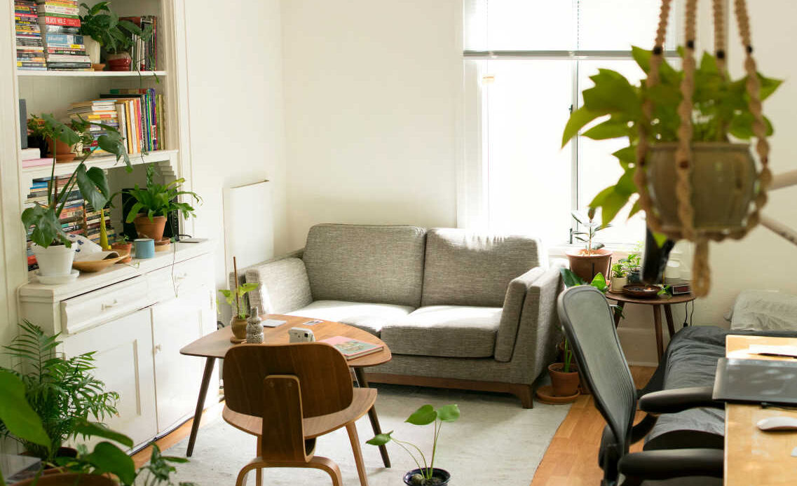 Gray loveseat near wooden table