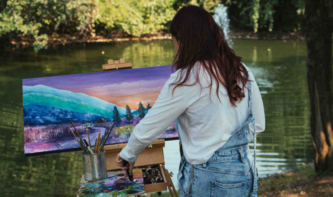 Artist painting outdoors on an easel