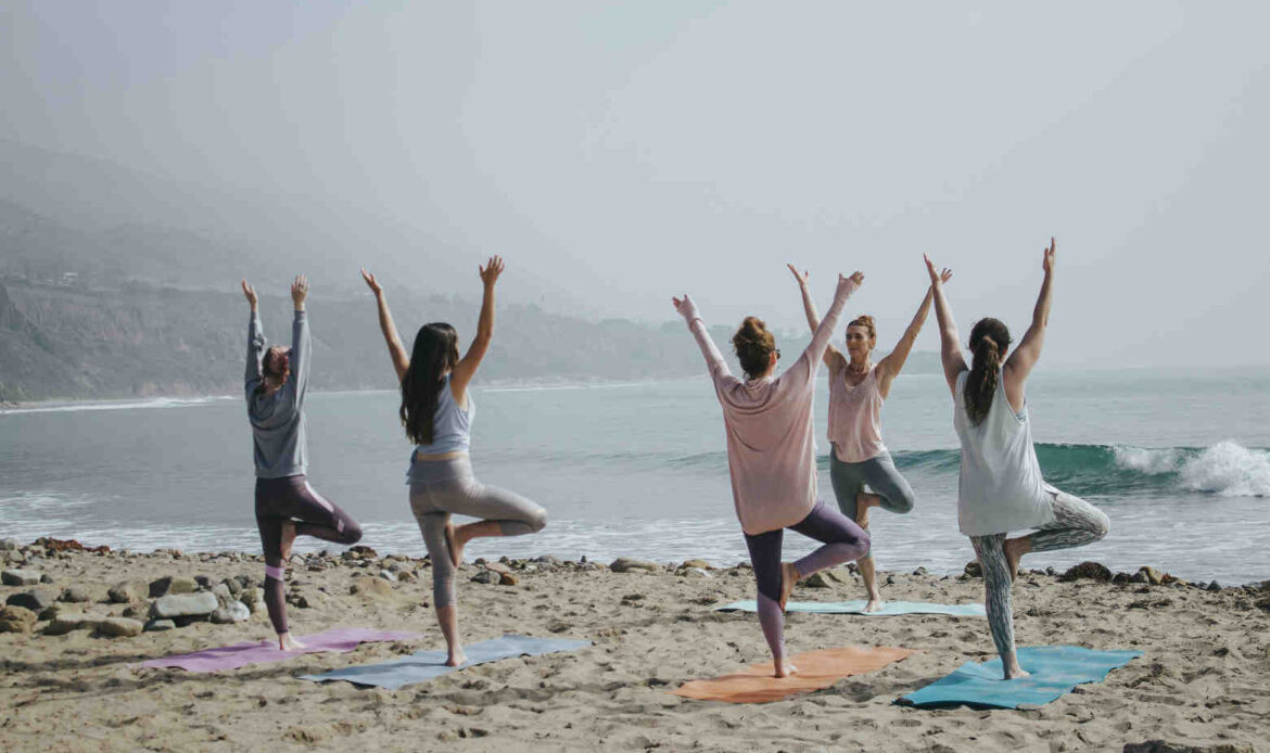Five women standing on a beach