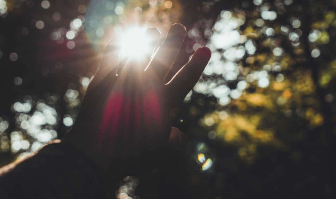 Hand reaching toward light