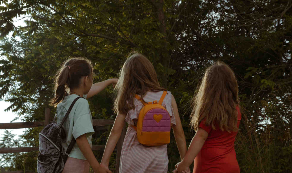 Young girls holding hands while walking together