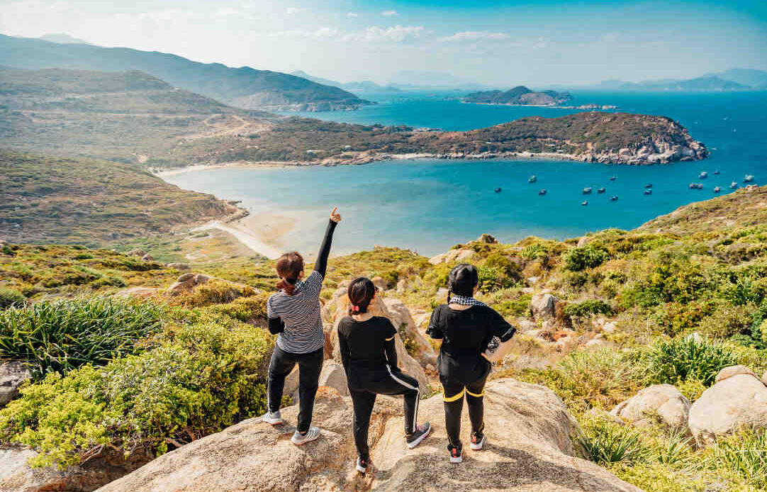 Three women on a mountain summit