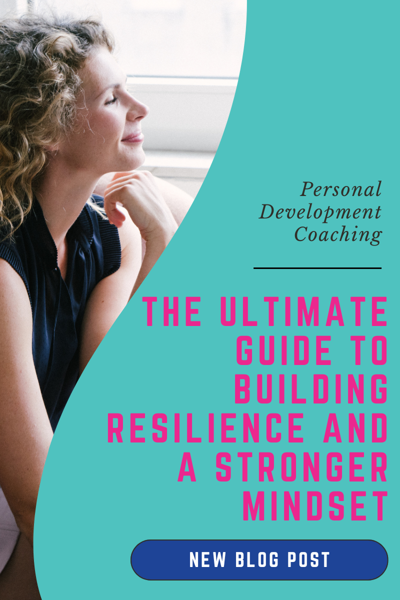 Woman reflecting by a window symbolizing growth and resilience in personal development coaching
