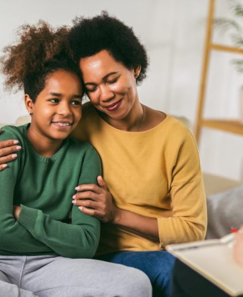 Mother and her teenager daughter talking with therapist.