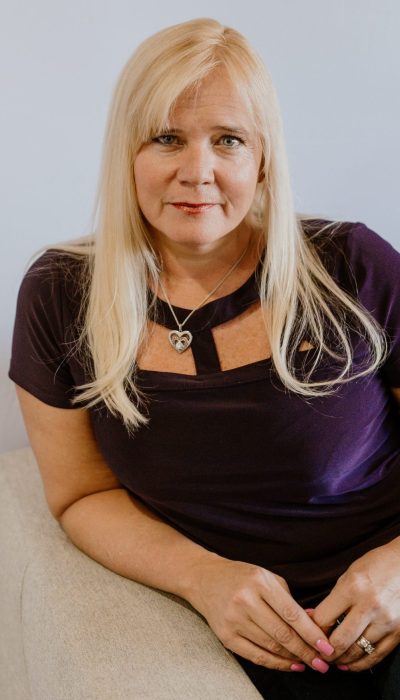 Dr. B sitting on a couch, preparing for her Lifestyle Session.