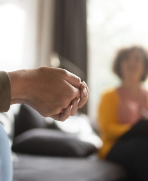 Close-up of hands during a psychoeducation meeting.